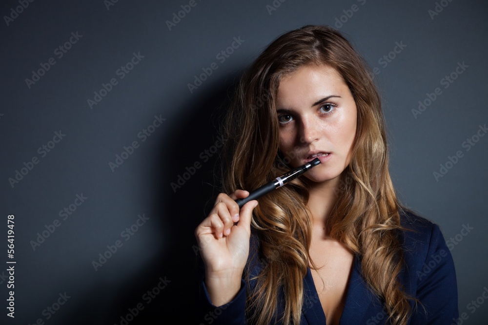 Elegant woman with e-cigarette wearing suit