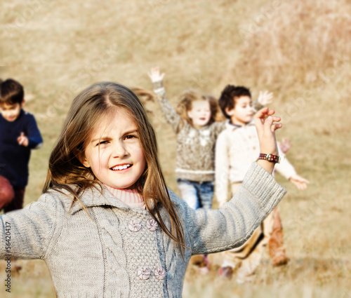 Happy children running on meadow