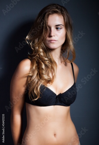 Portrait of sexy woman in lingerie on dark background © leszekglasner