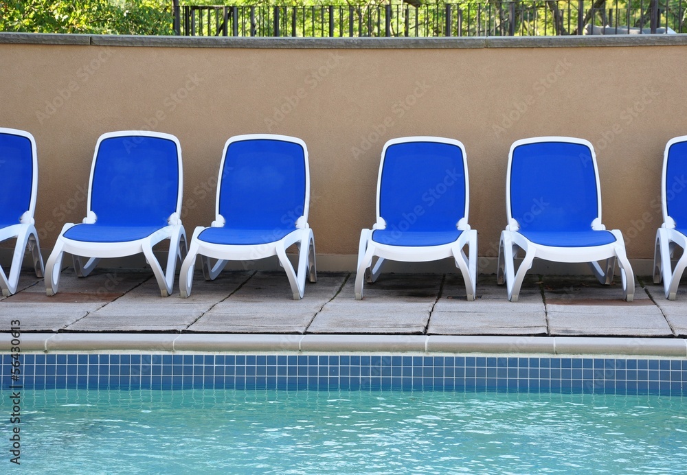 Blue and white chairs near the pool