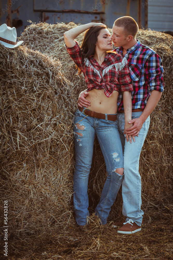 couple embracing near hay couple embracing near hay