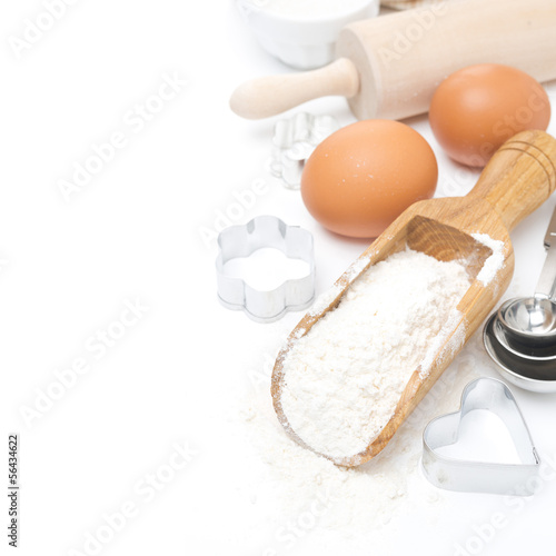 scoop with wheat flour, rolling pin, eggs, cookie cutters