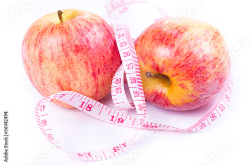 Apple and measuring tape isolated on white background.