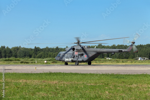 The military helicopter at the airfield preparing for take-off