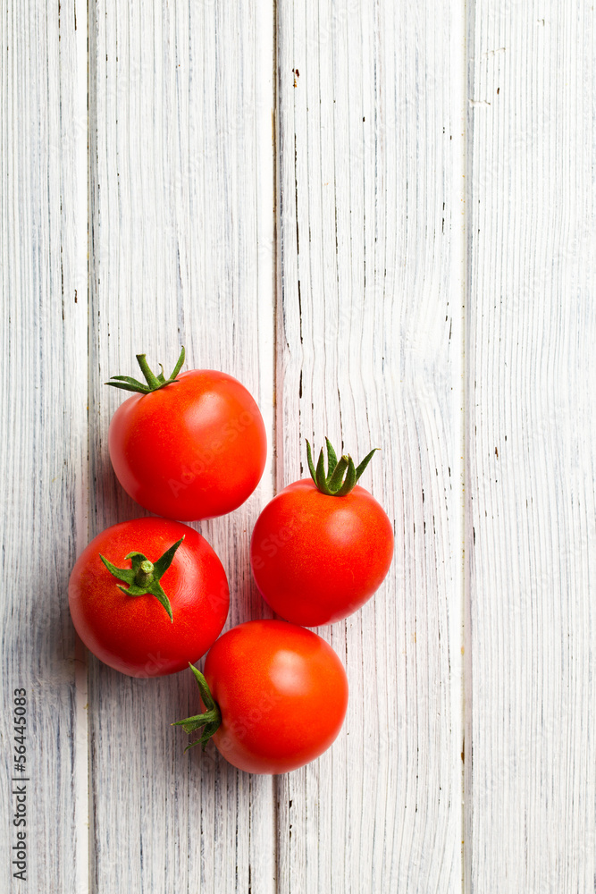 red tomatoes on wooden table red tomatoes on wooden table