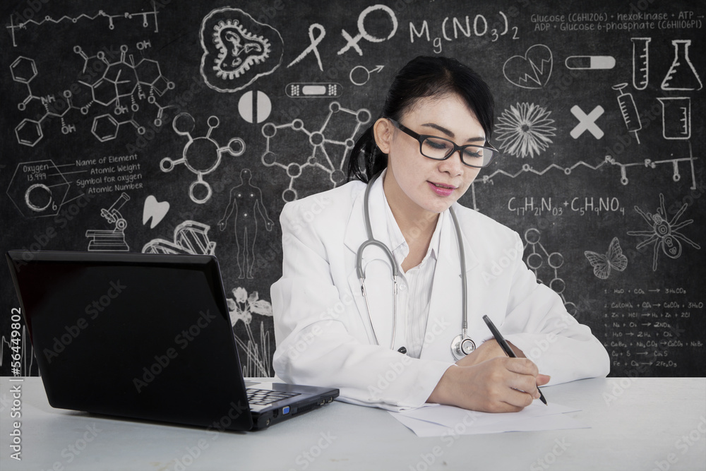 Beautiful doctor write prescription at lab Beautiful doctor write prescription at lab