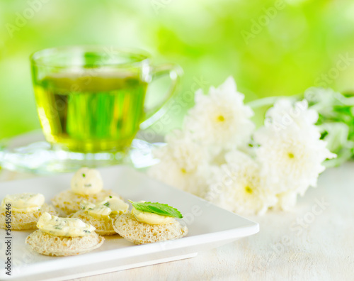 Several canapes and cup of herbal tea.