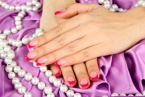 Female hands on color fabric background