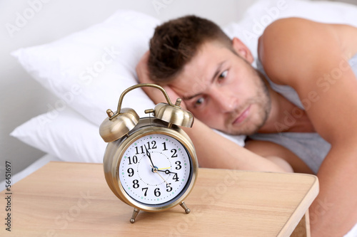 Handsome young man in bed