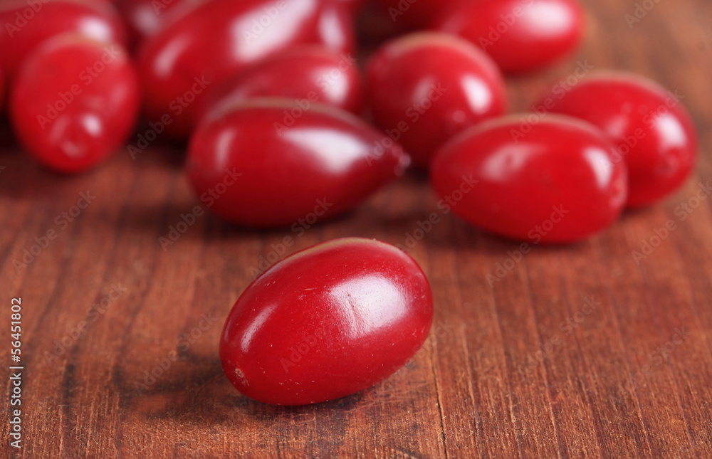 Fresh cornel berries on wooden background Fresh cornel berries on wooden background