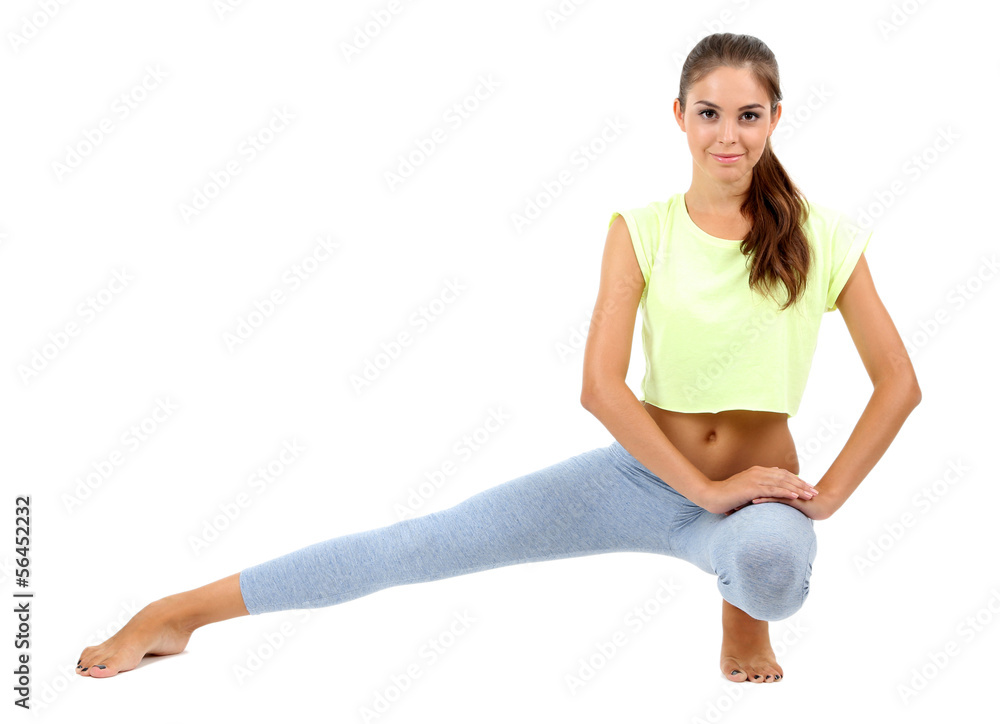 Beautiful young girl doing exercises isolated on white Beautiful young girl doing exercises isolated on white