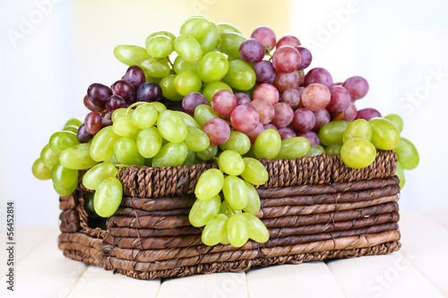 Ripe green and purple grapes in basket