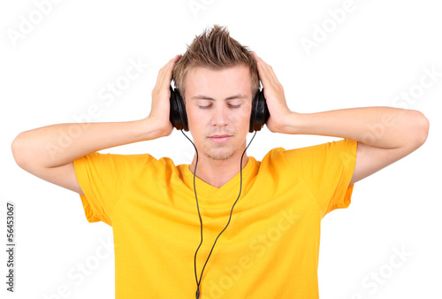 Handsome young man listening to music isolated on white