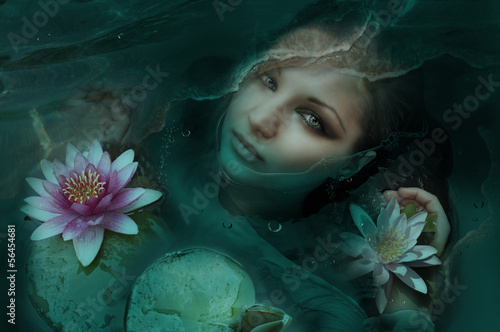 Beautiful woman in water with Lotus flowers