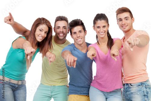 Happy group of friends saying pointing at camera