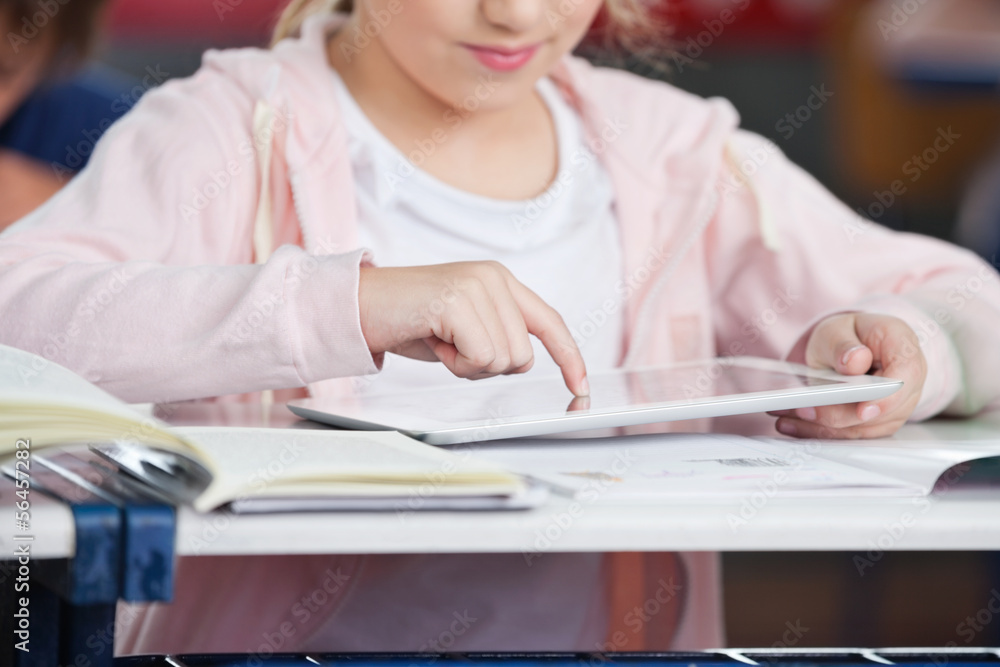 Midsection Of Schoolgirl Using Tablet At Desk Midsection Of Schoolgirl Using Tablet At Desk