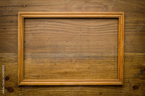 Old wooden frame on wood background