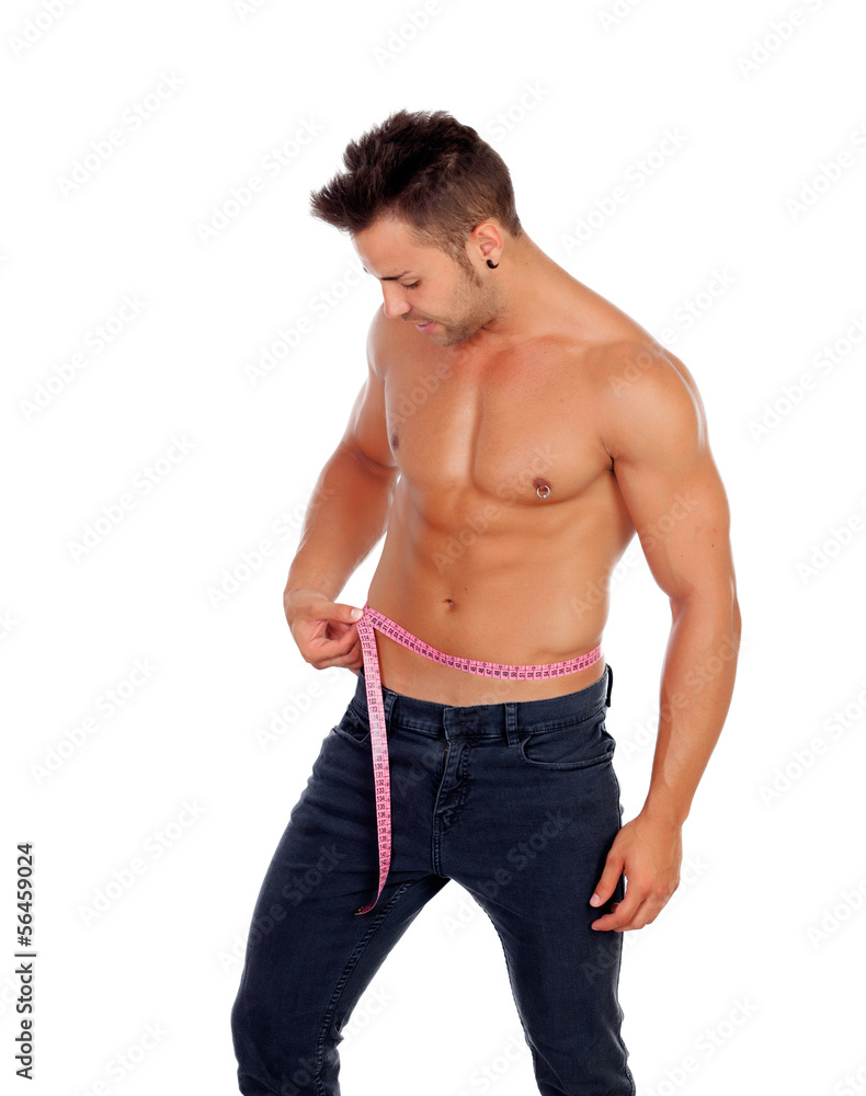 Fototapeta premium Men with perfect abs measuring his waist