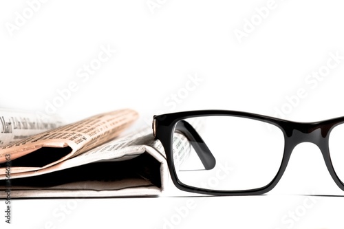 glasses near financial newspaper