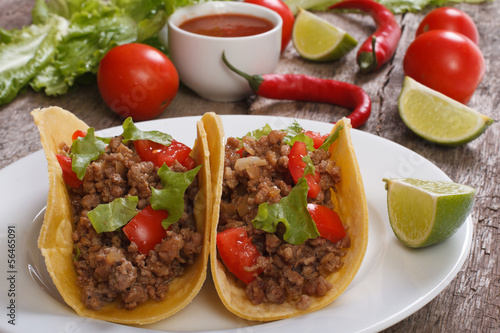 Tacos stuffed with ground beef  and chili sauce on