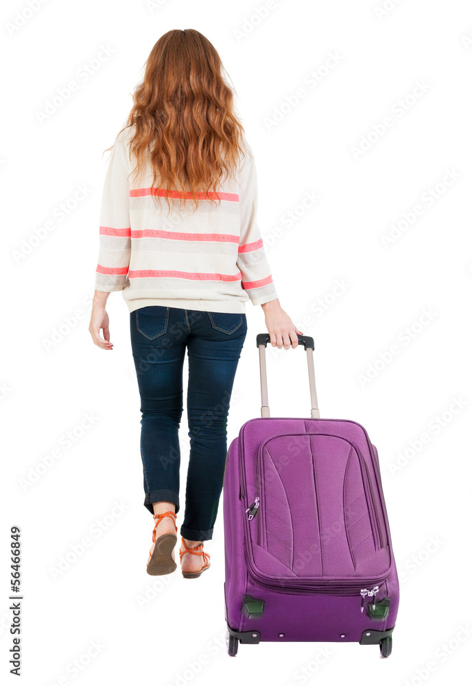 back view of walking woman with suitcase. back view of walking woman with suitcase.