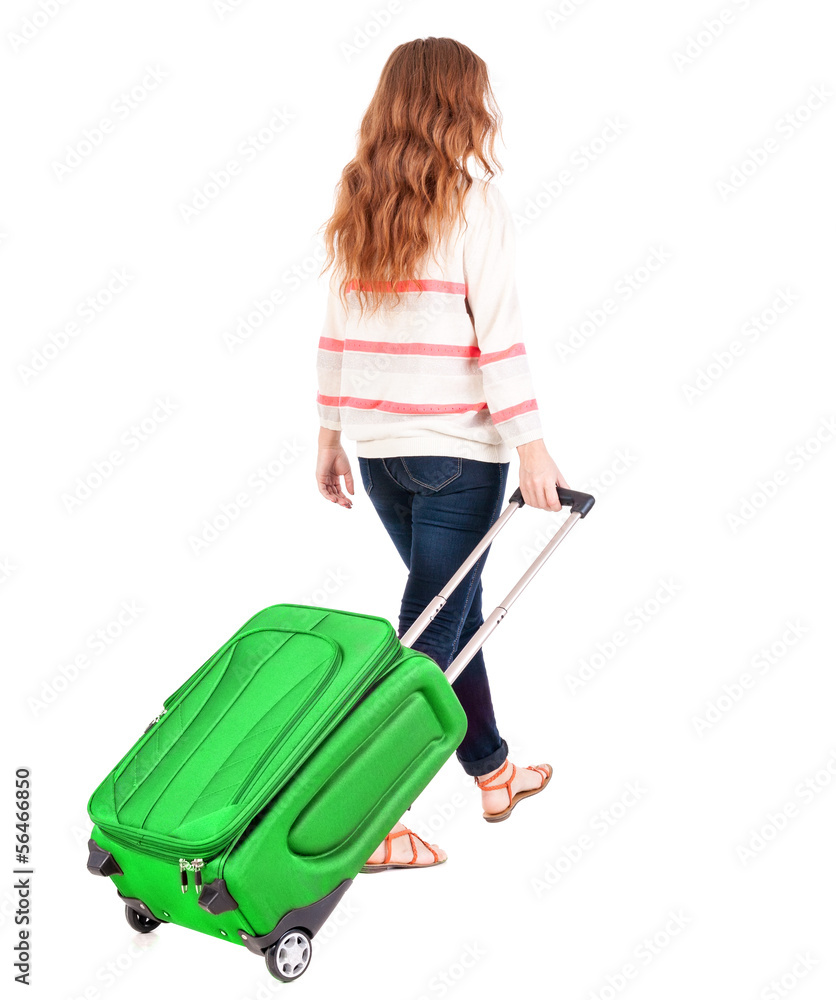 back view of walking woman with suitcase. back view of walking woman with suitcase.