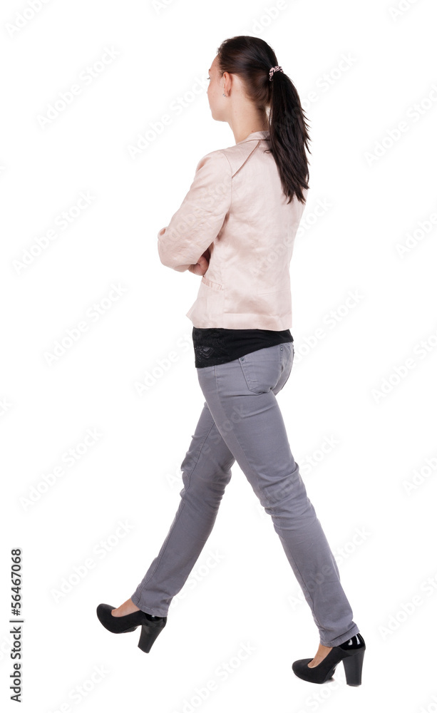 back view of walking woman in jeans back view of walking woman in jeans
