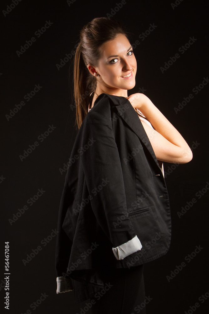 Portrait of beautiful woman posing in studio with jacket
