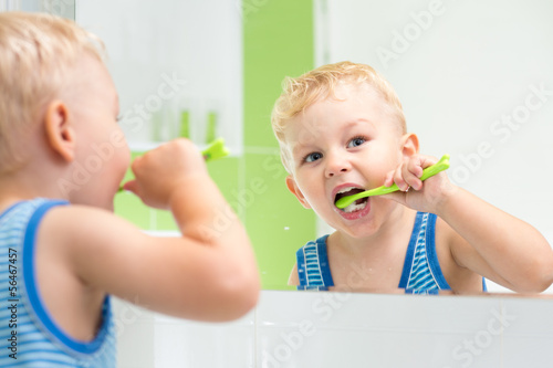 kid boy brushing teeth photo