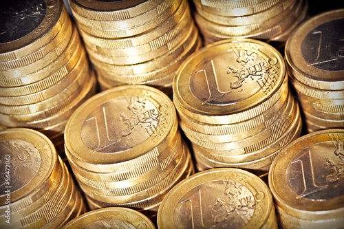 Columns of one euro coins. Selective focus.