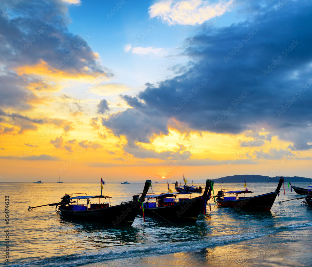 Traditional thai boats at sunset beach