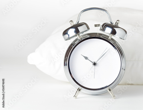Alarm clock and white pillow