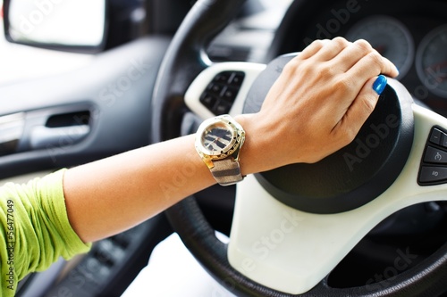 Woman hand pressing on a car horn