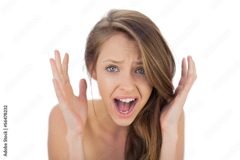 Annoyed brunette model raising her hands and screaming Annoyed brunette model raising her hands and screaming