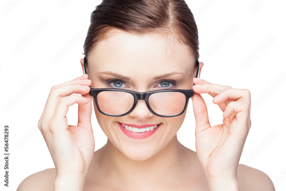 Smiling natural model looking over her classy glasses Smiling natural model looking over her classy glasses
