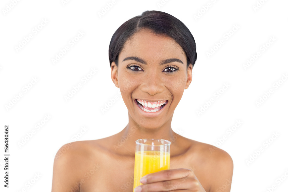 Smiling attractive model holding glass of orange juice Smiling attractive model holding glass of orange juice