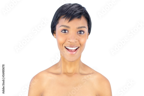 Surprised black haired woman smiling at camera