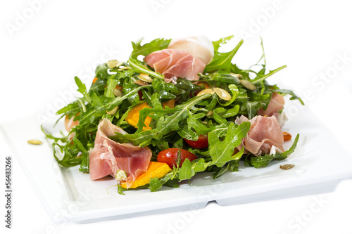 salad of arugula ham cheese on a white background