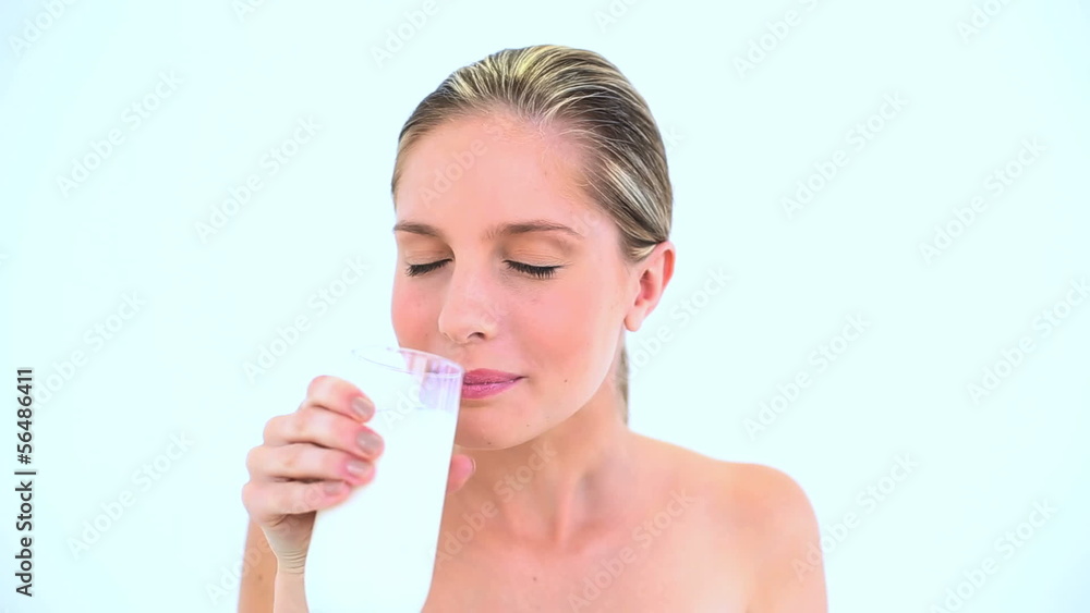 Smiling woman drinking a glass of milk Smiling woman drinking a glass of milk