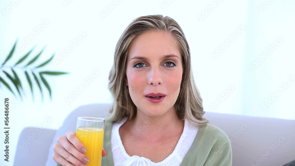 Beautiful woman drinking a glass of orange juice Beautiful woman drinking a glass of orange juice