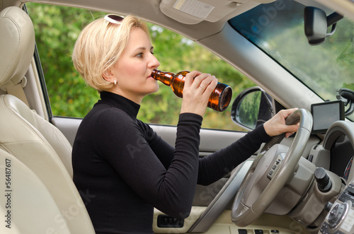 Young female driver drinking and driving © Daddy Cool