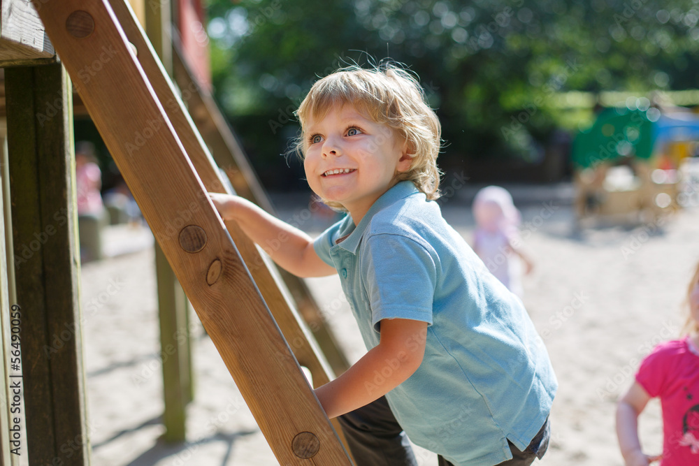 Little boy having fun on city playground on sunny day Little boy having fun on city playground on sunny day