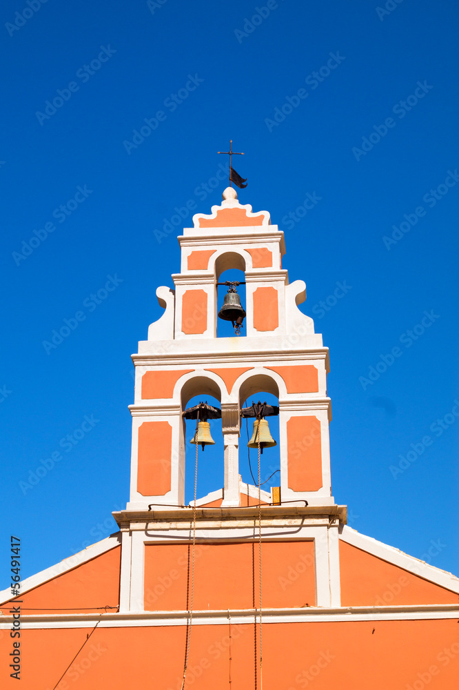 Church bell hanging from arch of bell tower, Fiskardo Kefallonia