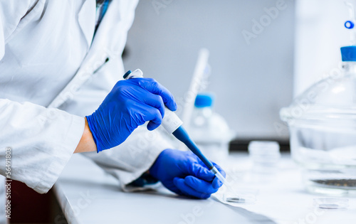 Hands of a researcher carrying out scientific research experimen