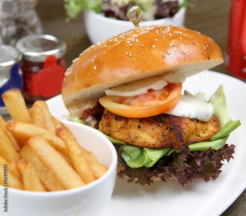 cajun chicken burger with salad and fries