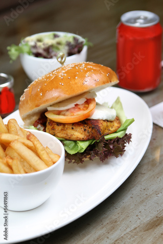 cajun chicken burger with salad and fries