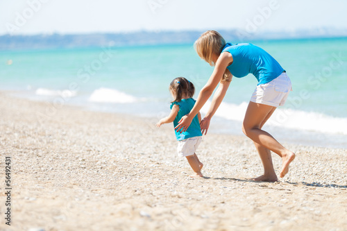 little girl and mother have good time at the beach
