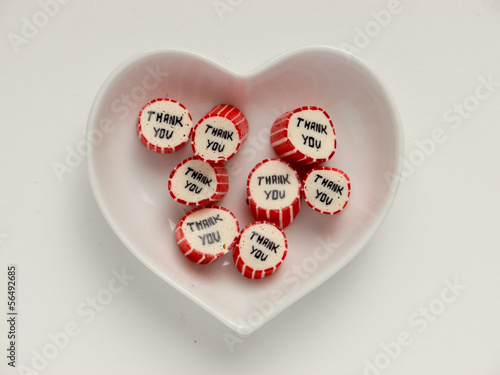 Heart-shaped plate with thank you candies photo