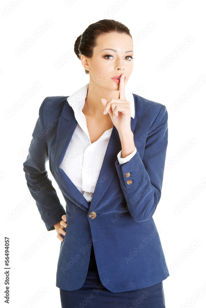 Attractive business woman with finger on lips Attractive business woman with finger on lips