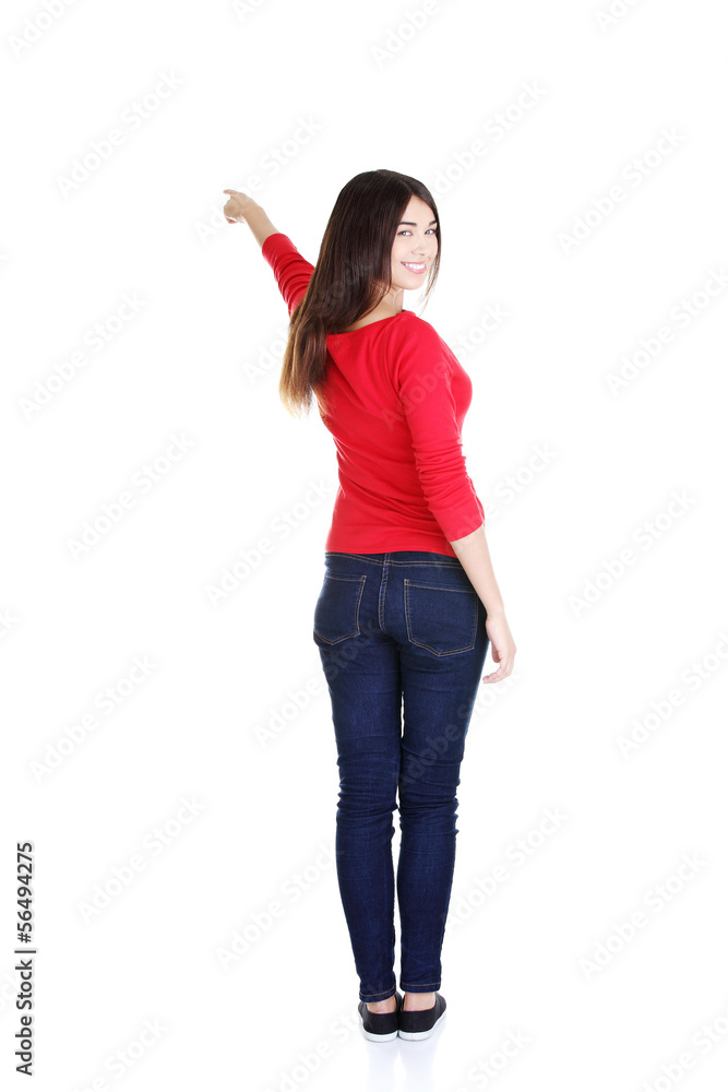 Happy , excited young woman pointing on copy space Happy , excited young woman pointing on copy space